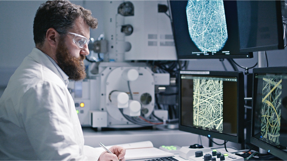 A scientist studying fibers on computer screens 